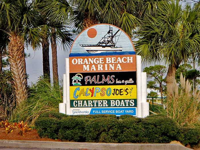 The Orange Beach Marina sign indicates a left turn to the charter boat Intimidator.